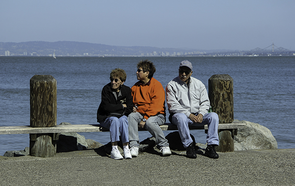 three people on a bench