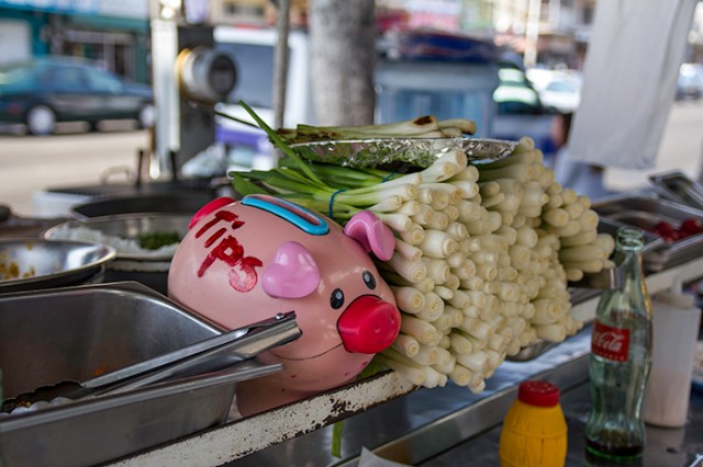 tip jar and fried onions on a street cart