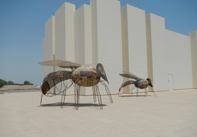 flies in front of Qal' at al-Bahrain Museum