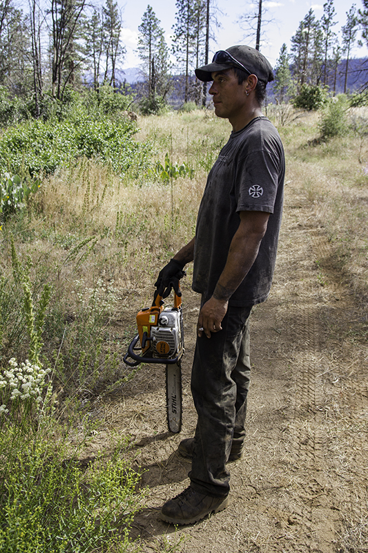 Stacy posing with chainsaw