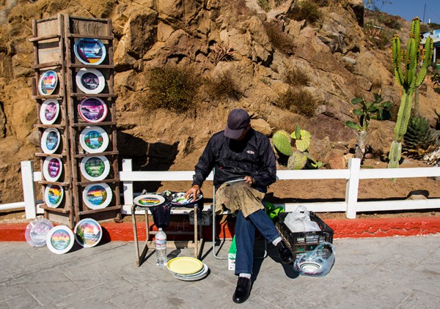 man finger-painting plates