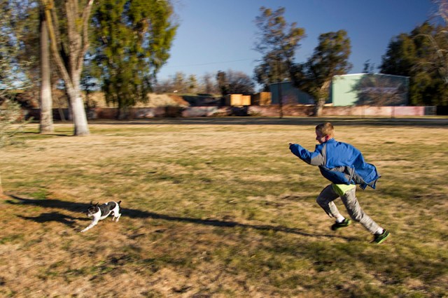 Johnathan chasing Sparky at the park