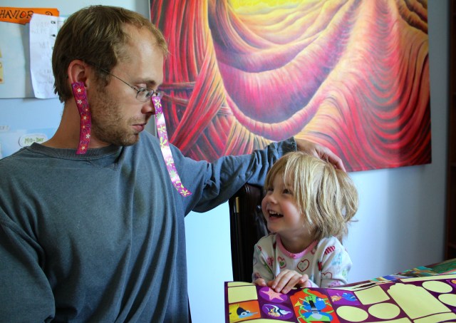 Jake and Lyra playing with stickers