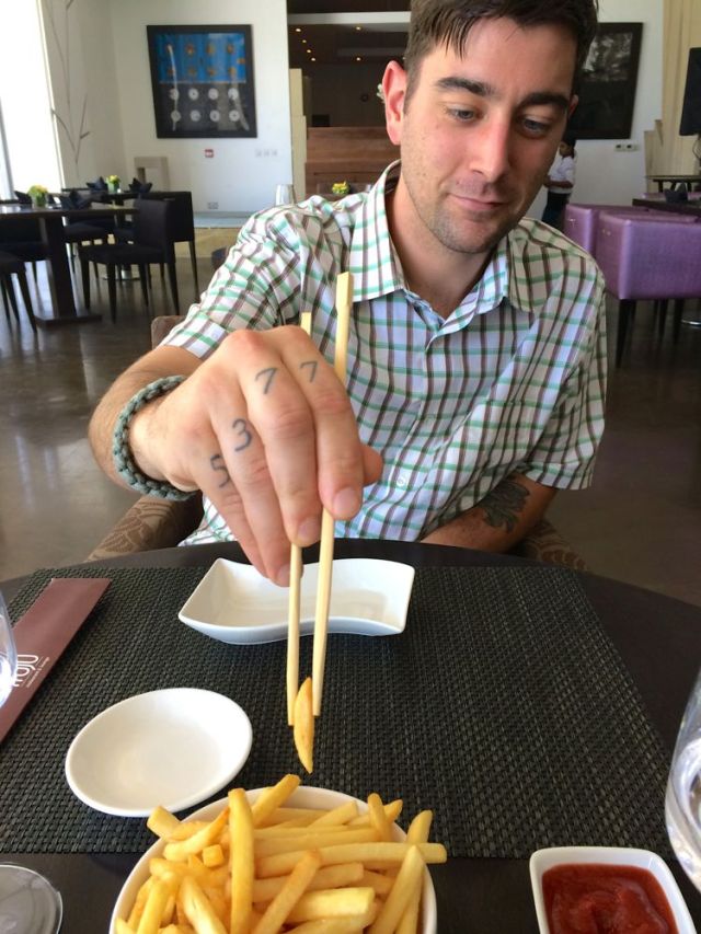 eating French fries with chopsticks