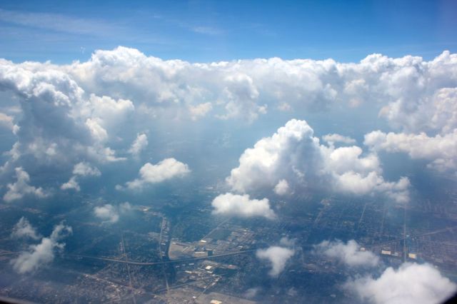 a bustling metropolis under fluffy clouds