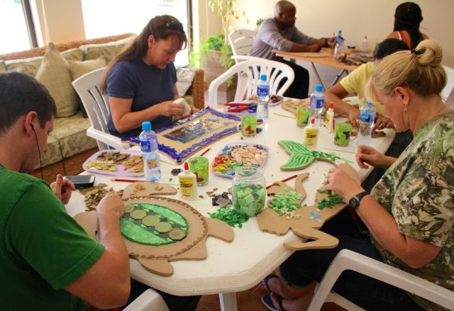 a turtle, mirror, camel, and mermaid with couple in background