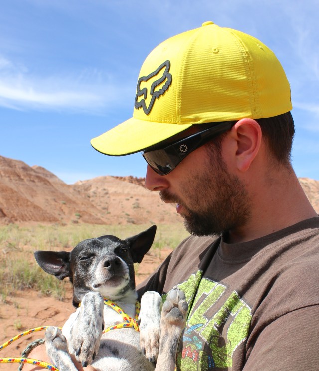Caleb carrying Sparky through the desert