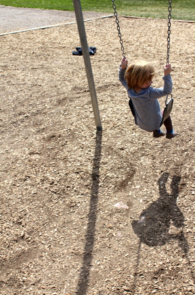 Lyra watching her shadow on the swing