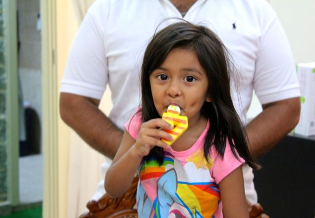 Angel enjoying the icing, Sabi behind her