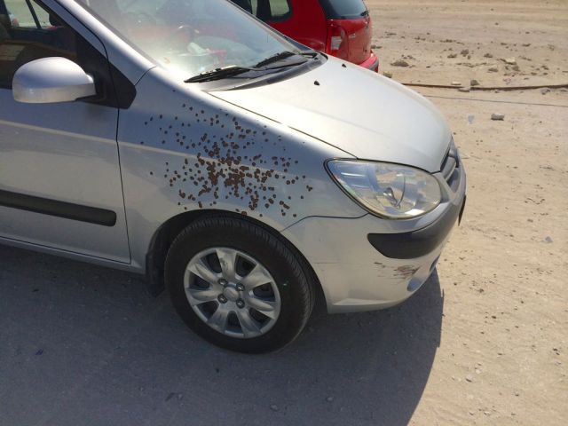 a car in the dirt lot by base