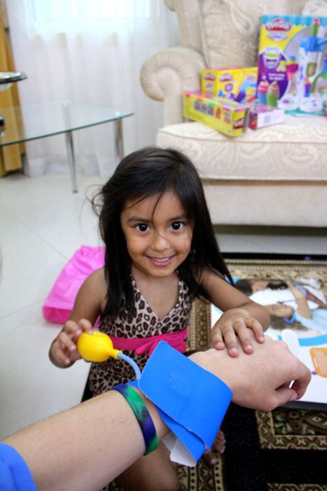the birthday girl checking my blood pressure (cake meter) 
